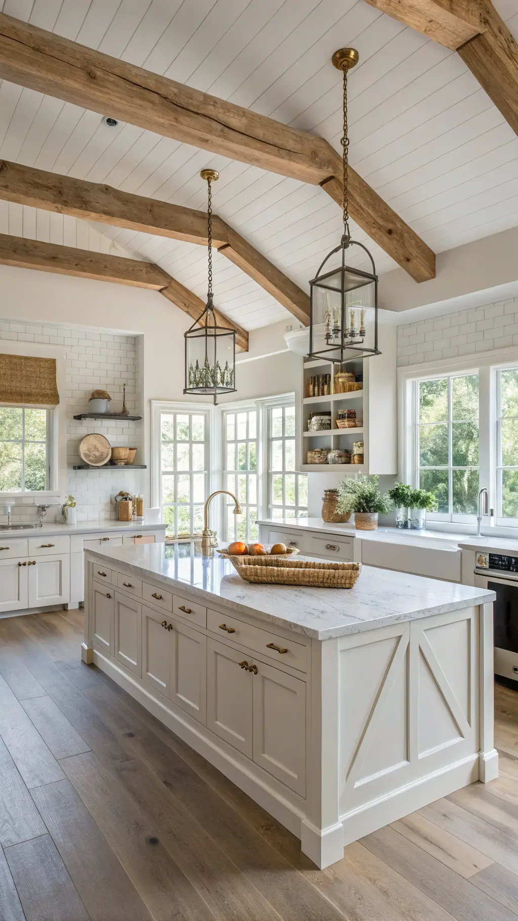 Bright and airy kitchen with high ceilings, white oak flooring, floor-to-ceiling windows, marble-topped island, vintage cutting boards displayed on wall, white pottery on open shelves, brass hardware, and morning light casting shadows from woven pendant lights.
